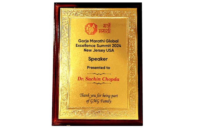 Garje Marathi Global Excellence Summit 2024 speaker plaque presented to Dr. Sachin Chopda